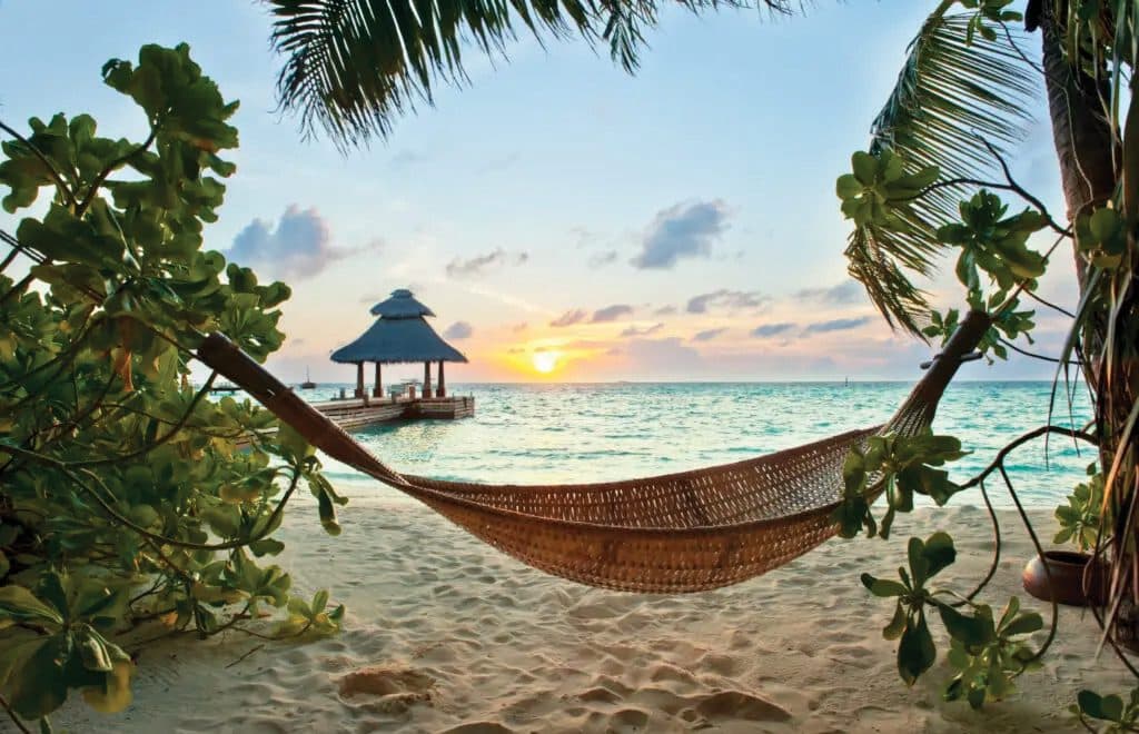 A hammock at sunset on the Belize coast